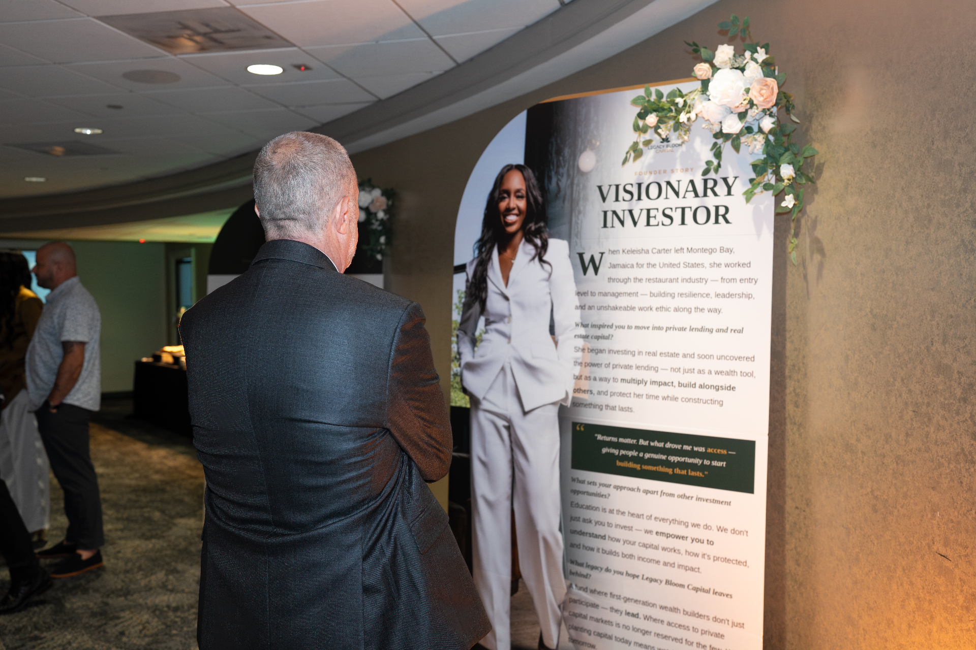 Guest reading the founder story display at the Legacy Bloom Capital launch event